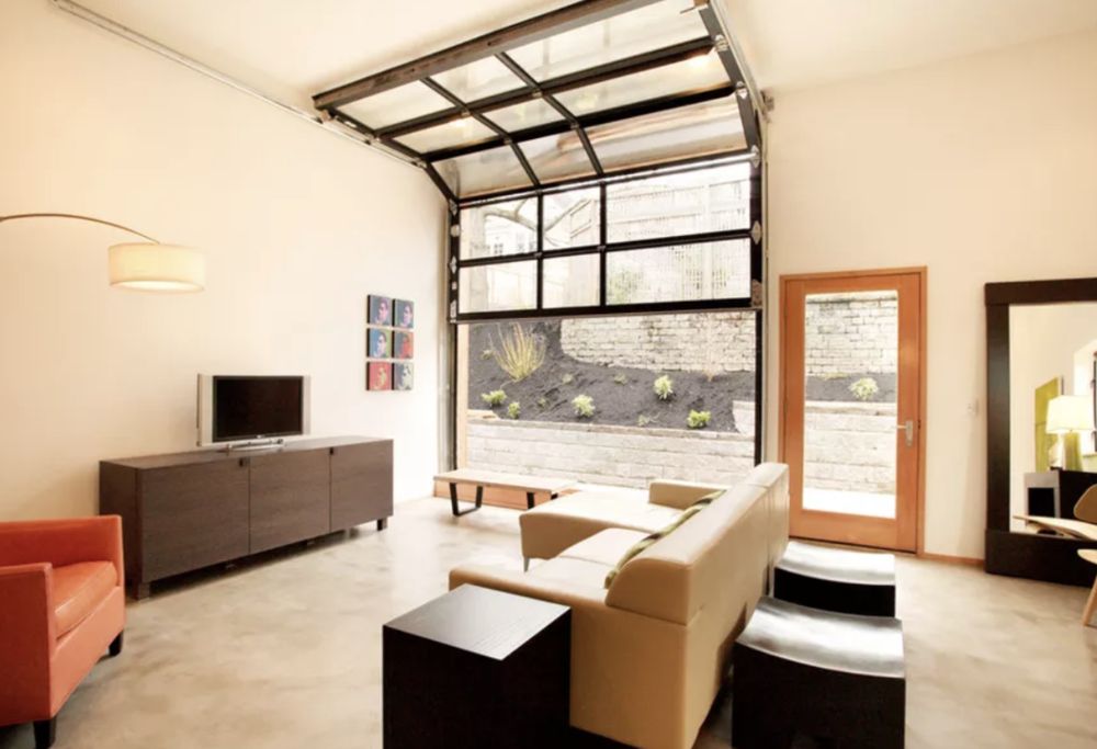 Loft living room with glass garage-door wall