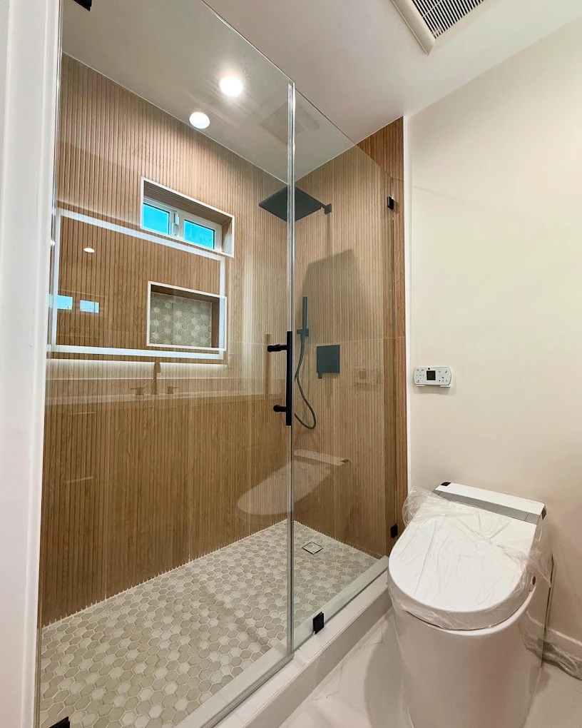 Wood-look walk-in shower with mosaic floor