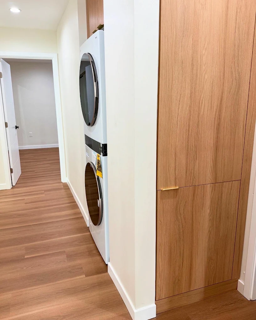 Hallway with built-in laundry & oak cabinetry