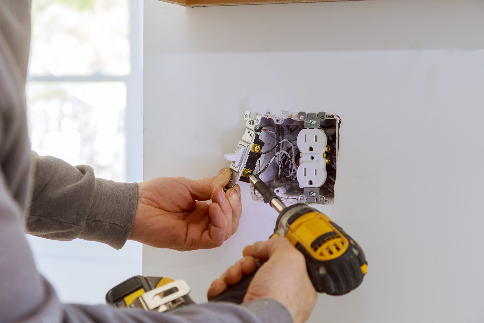 Electrician testing a panel with a multimeter