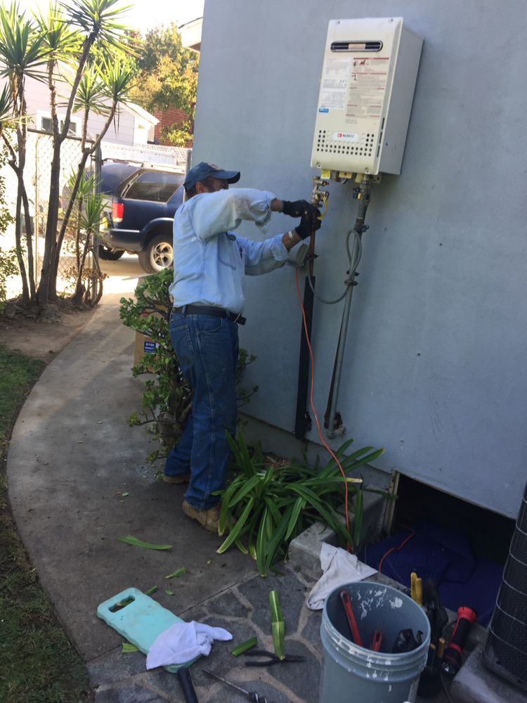 Plumber tightening a pipe fitting