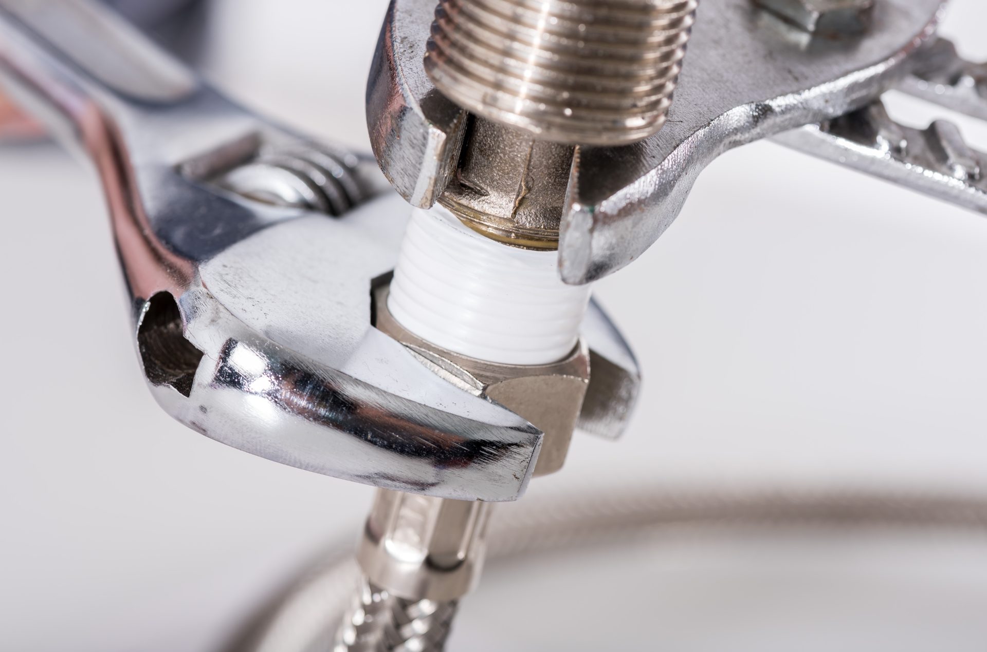 Plumber tightening a pipe fitting